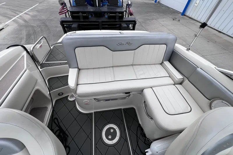 Slide: The Image of 2010 Sea Ray 220 Sundeck interior with white seating and sleek design. - 14