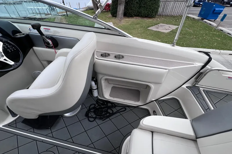 Slide: The Image of Interior of a 2010 Sea Ray 220 Sundeck boat with seating and controls. - 15