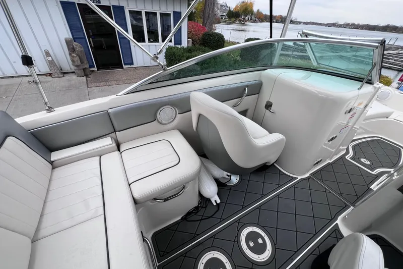 Slide: The Image of 2010 Sea Ray 220 Sundeck interior with white seating and sleek design. - 16