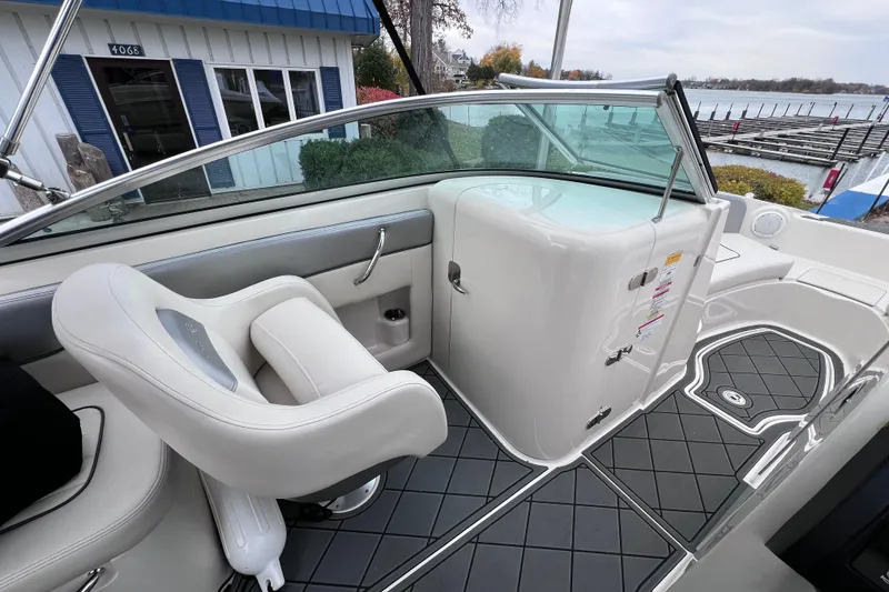 Slide: The Image of 2010 Sea Ray 220 Sundeck interior with white seating and sleek design. - 17