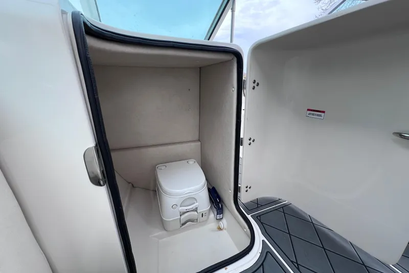 Slide: The Image of Interior view of 2010 Sea Ray 220 Sundeck boat's compact bathroom area. - 19