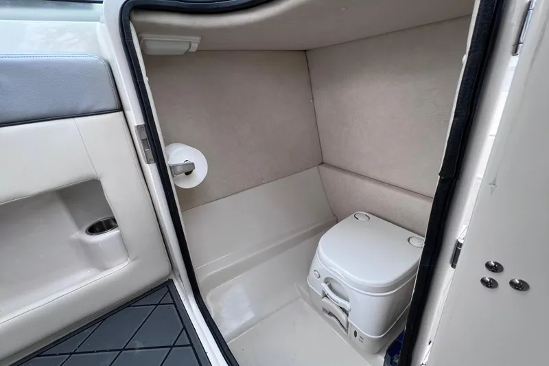 Slide: The Image of Interior of 2010 Sea Ray 220 Sundeck boat with compact marine toilet. - 20