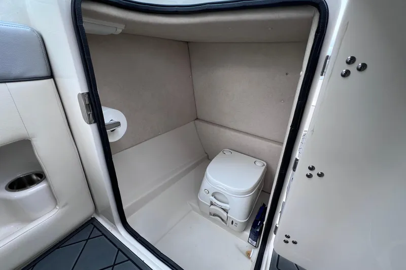 Slide: The Image of Interior of 2010 Sea Ray 220 Sundeck boat with compact toilet. - 21