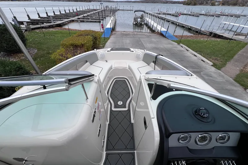 Slide: The Image of 2010 Sea Ray 220 Sundeck boat interior with view of dock and lake. - 23