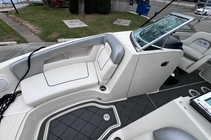 Slide: The Image of 2010 Sea Ray 220 Sundeck interior with white seating and modern design. - 27