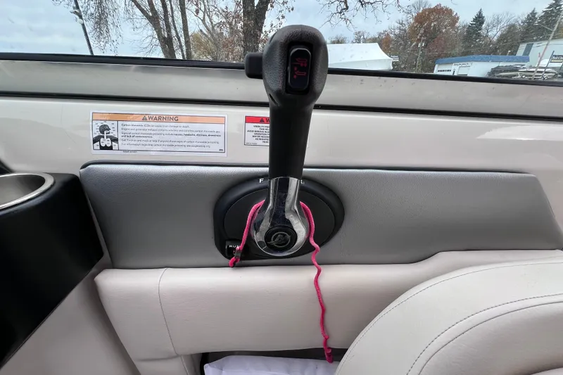 Slide: The Image of Throttle control lever on a 2010 Sea Ray 220 Sundeck boat interior. - 30