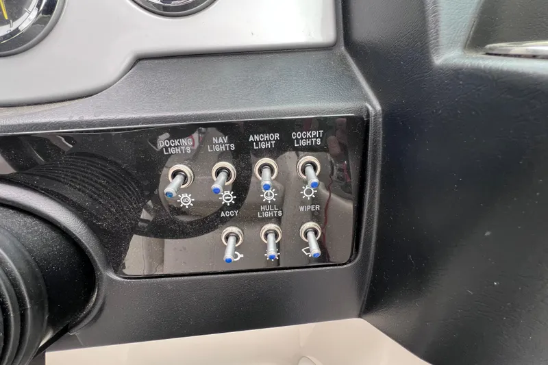 Slide: The Image of Control panel of a 2010 Sea Ray 220 Sundeck boat with labeled switches. - 31