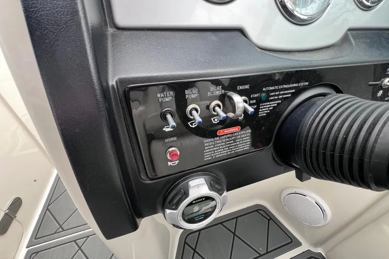 Slide: The Image of Control panel of a 2010 Sea Ray 220 Sundeck boat with switches and gauges. - 32