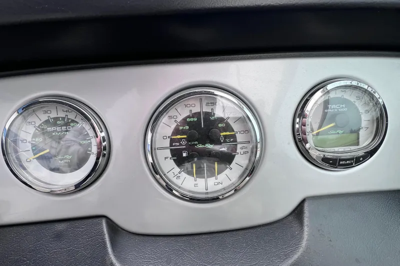 Slide: The Image of Dashboard gauges of a 2010 Sea Ray 220 Sundeck boat, showing speed, fuel, and RPM. - 35