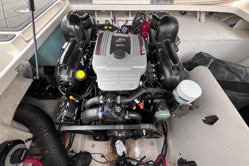 Slide: The Image of Engine compartment of a 2010 Sea Ray 220 Sundeck boat, featuring a MerCruiser engine. - 39
