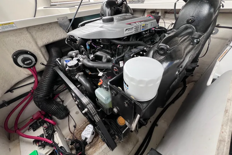 Slide: The Image of Engine compartment of a 2010 Sea Ray 220 Sundeck boat, showcasing Mercury engine components. - 42