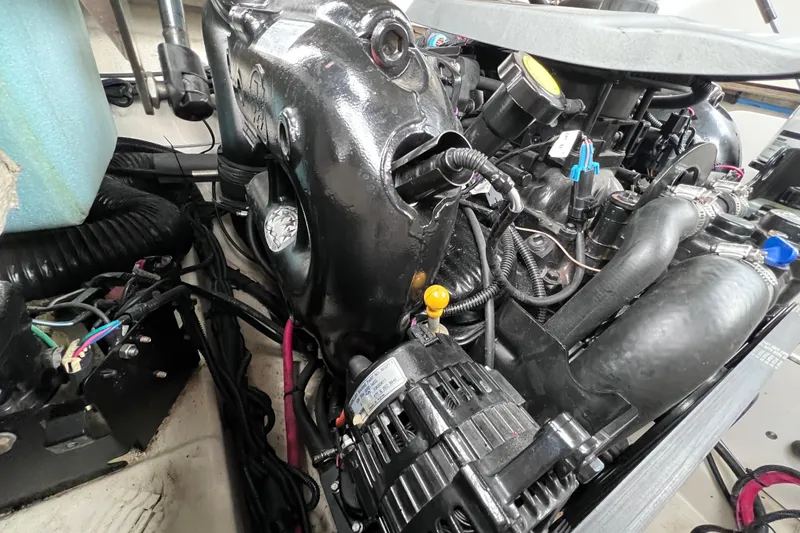 Slide: The Image of Engine compartment of a 2010 Sea Ray 220 Sundeck boat, showcasing detailed components. - 43