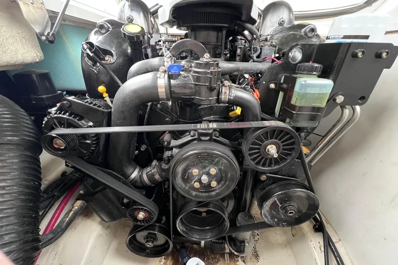 Slide: The Image of Engine of a 2010 Sea Ray 220 Sundeck boat, showcasing belts and components. - 44