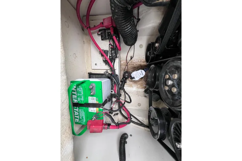 Slide: The Image of Engine compartment of a 2010 Sea Ray 220 Sundeck with visible battery and wiring. - 46