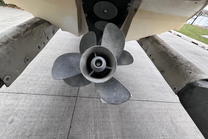 Slide: The Image of Propeller of a 2010 Sea Ray 220 Sundeck boat on a concrete surface. - 50