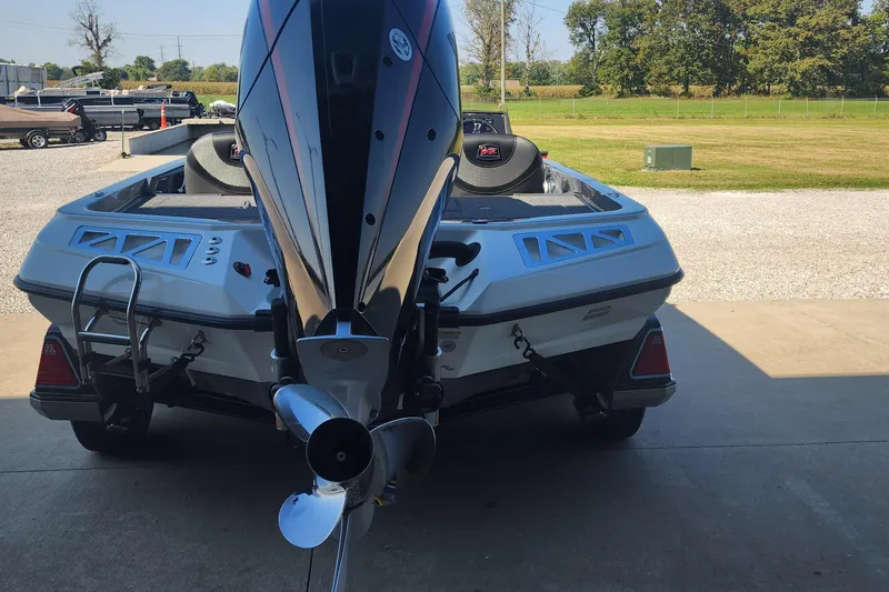 Slide: The Image of 2020 Ranger Z520L boat with powerful outboard motor, parked outdoors on a sunny day. - 2