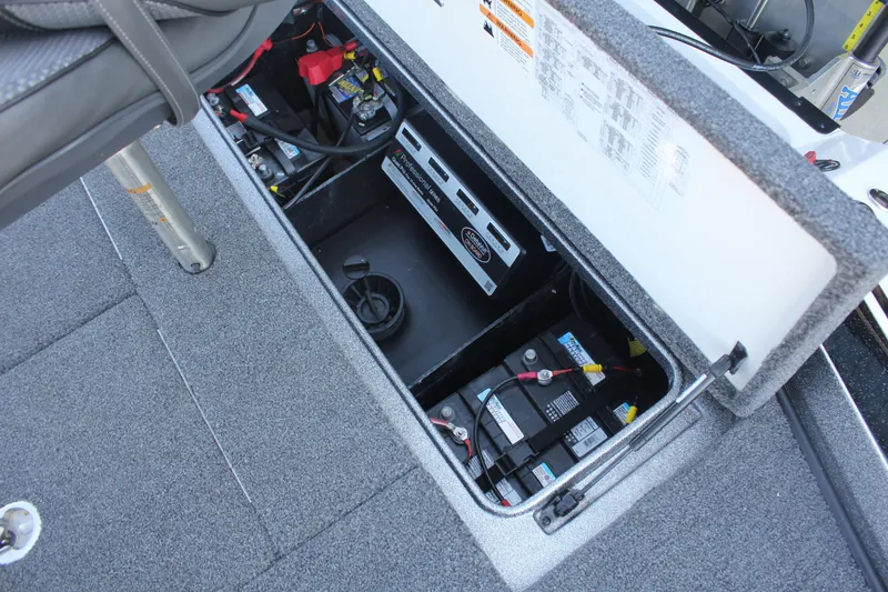 Slide: The Image of 2020 Ranger Z520L boat battery compartment with wiring and storage. - 20