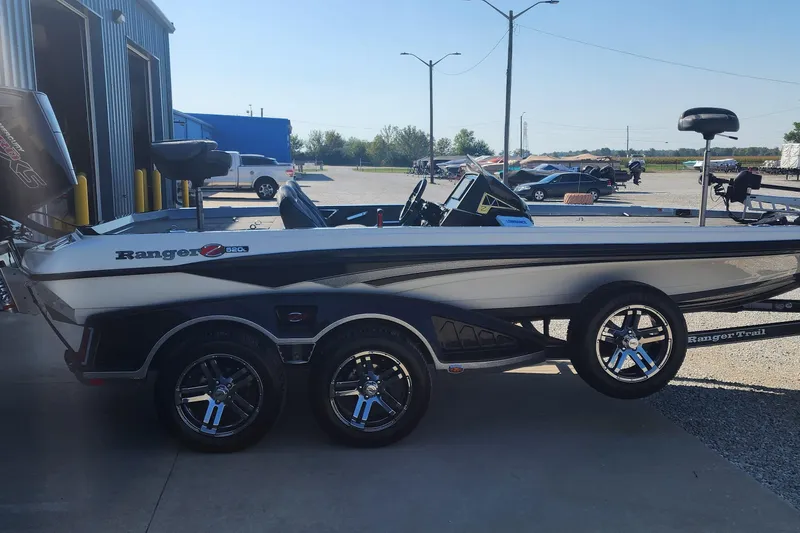 Slide: The Image of 2020 Ranger Z520L boat parked outside, showcasing sleek design and dual-axle trailer. - 3