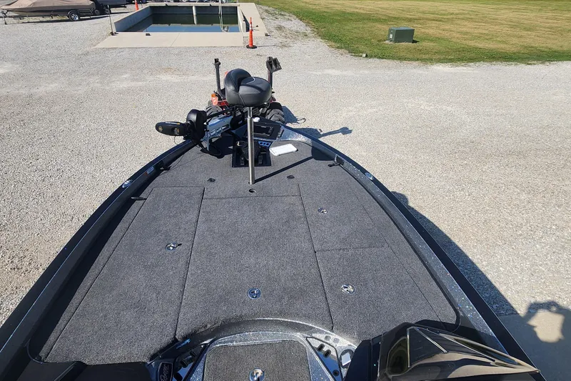 Slide: The Image of 2020 Ranger Z520L boat deck with fishing seat and equipment, parked on gravel. - 5