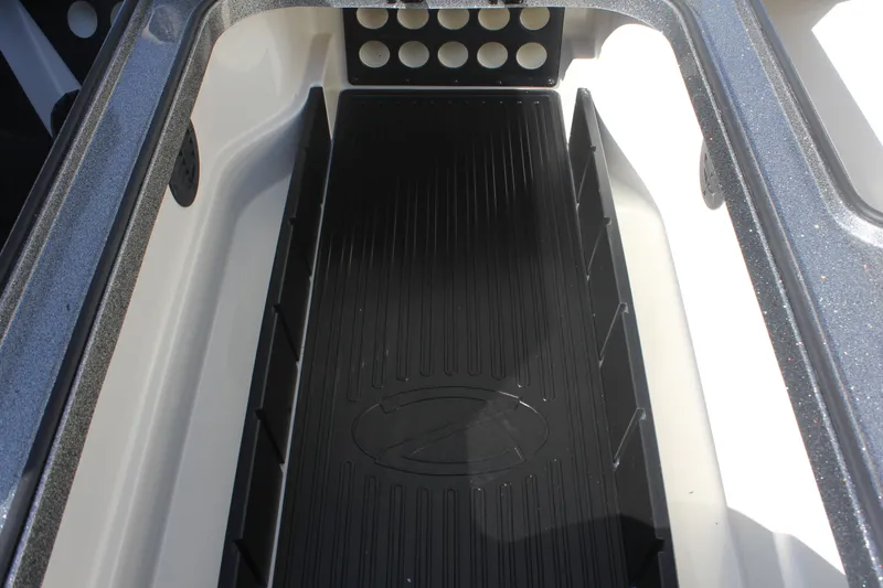 Slide: The Image of 2020 Ranger Z520L boat storage compartment with black mat and rod holders. - 7