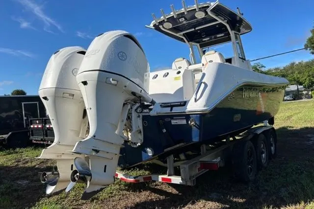 Slide: The Image of 2019 Everglades 290 Center Console boat with dual outboard engines on a trailer. - 4
