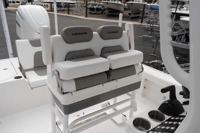 Slide: The Image of 2026 Caymas 26 HB boat interior with cushioned seating and cup holders. - 10