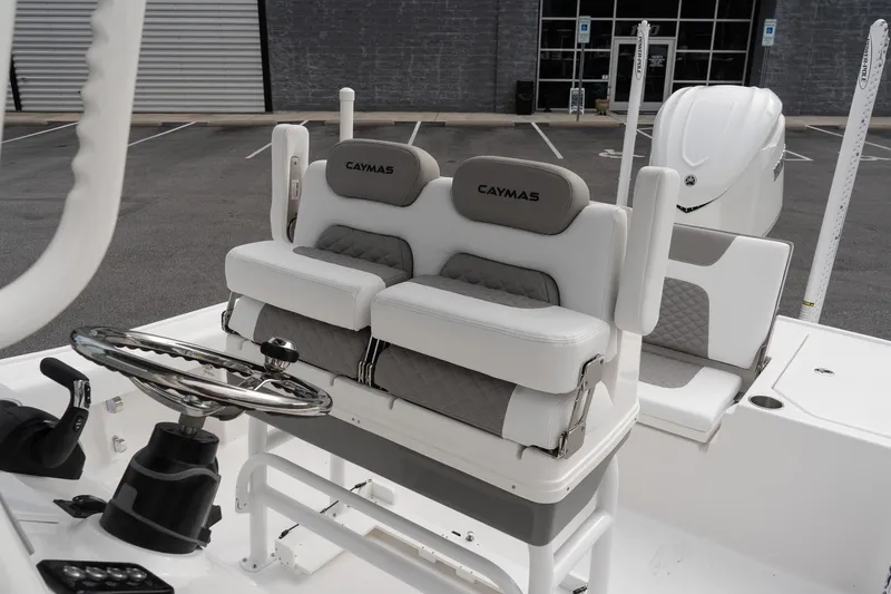 Slide: The Image of 2026 Caymas 26 HB boat interior with dual seats and steering wheel. - 11