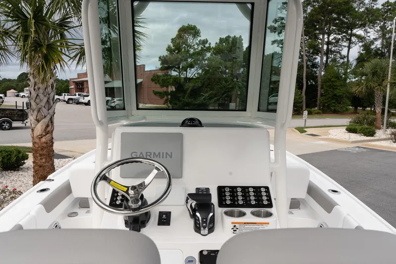 Slide: The Image of 2026 Caymas 26 HB boat dashboard with Garmin navigation system and steering wheel. - 12