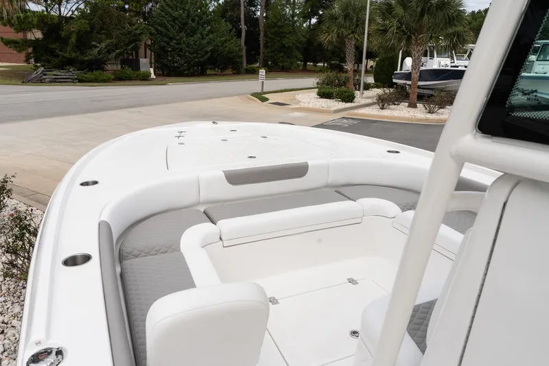 Slide: The Image of 2026 Caymas 26 HB boat interior with white seating and cup holders. - 15