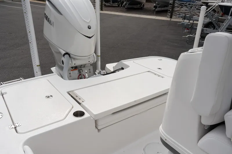 Slide: The Image of 2026 Caymas 26 HB boat deck with outboard motor and seating area. - 7