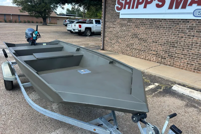 Slide: The Image of 2025 WeldBilt 1648 boat on trailer, parked outside Shipp's Marine building. - 1