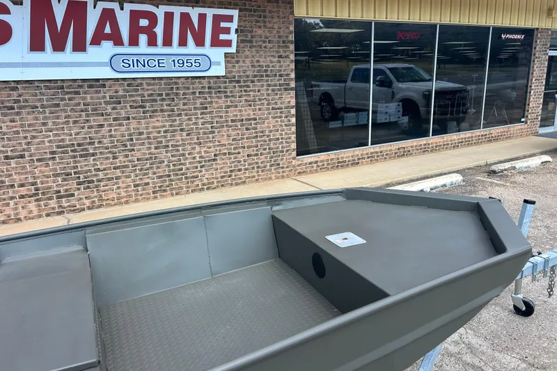 Slide: The Image of 2025 WeldBilt 1648 boat displayed outside a marine store with a brick facade. - 3