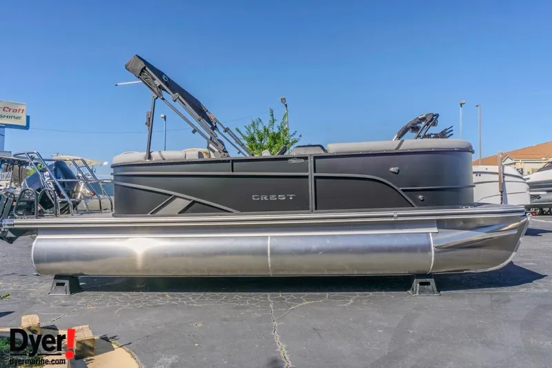 The Image of 2026 Crest Conquest 210 SLC pontoon boat displayed outdoors on a sunny day. - 0