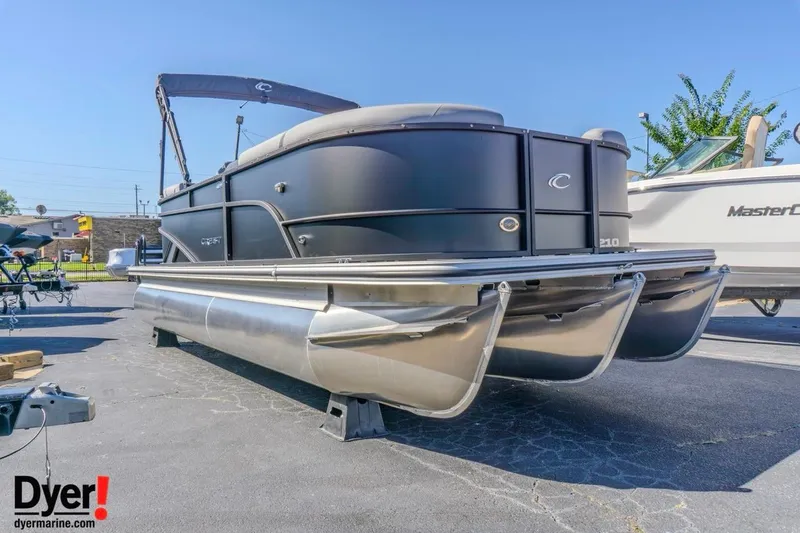 Slide: The Image of 2026 Crest Conquest 210 SLC pontoon boat displayed outdoors on a sunny day. - 2