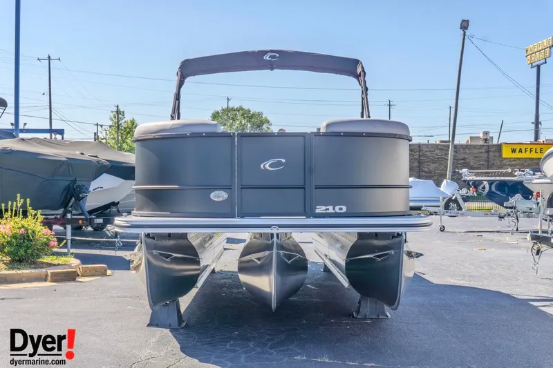 Slide: The Image of 2026 Crest Conquest 210 SLC pontoon boat displayed outdoors at a dealership. - 3