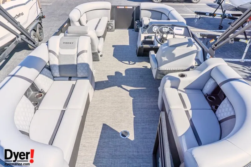 Slide: The Image of 2026 Crest Conquest 210 SLC pontoon boat interior with plush seating and modern dashboard. - 6