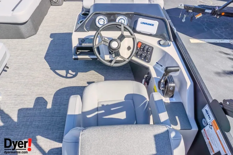Slide: The Image of 2026 Crest Conquest 210 SLC boat dashboard with steering wheel and control panel. - 7