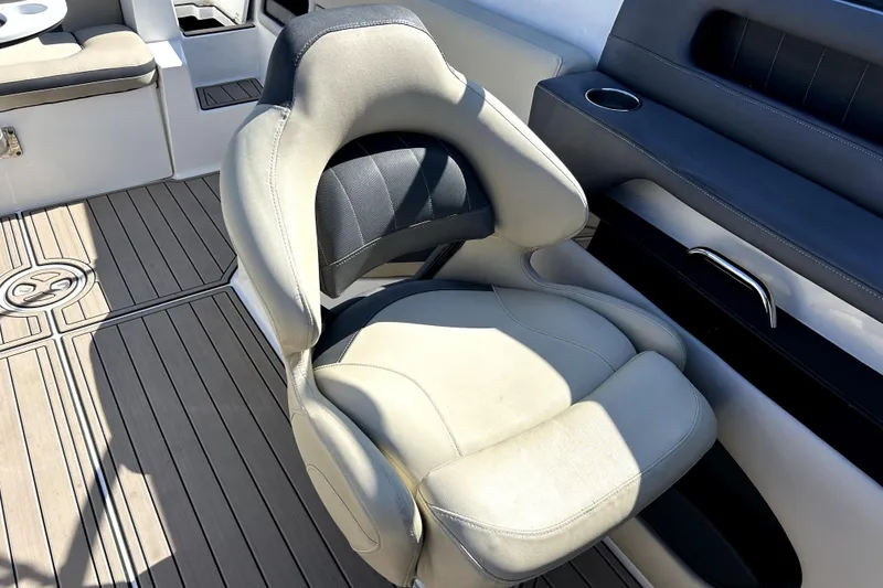 Slide: The Image of 2018 Rinker Q5 OB boat interior with cushioned seating and sleek design. - 11