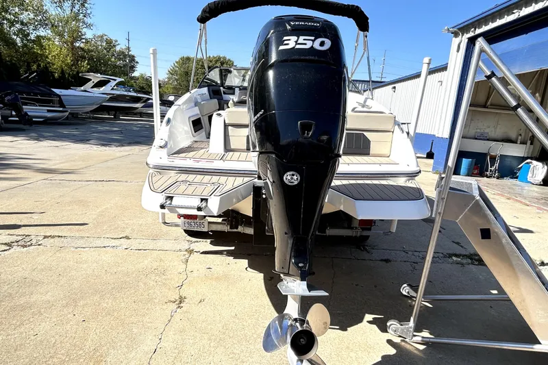 Slide: The Image of 2018 Rinker Q5 OB boat with powerful 350 Verado outboard motor, docked outdoors. - 14
