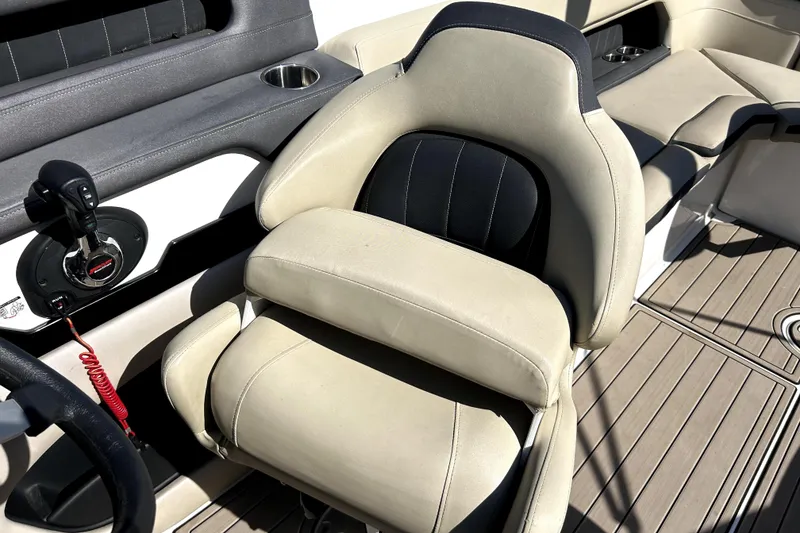 Slide: The Image of 2018 Rinker Q5 OB boat interior with beige seating and control panel. - 15