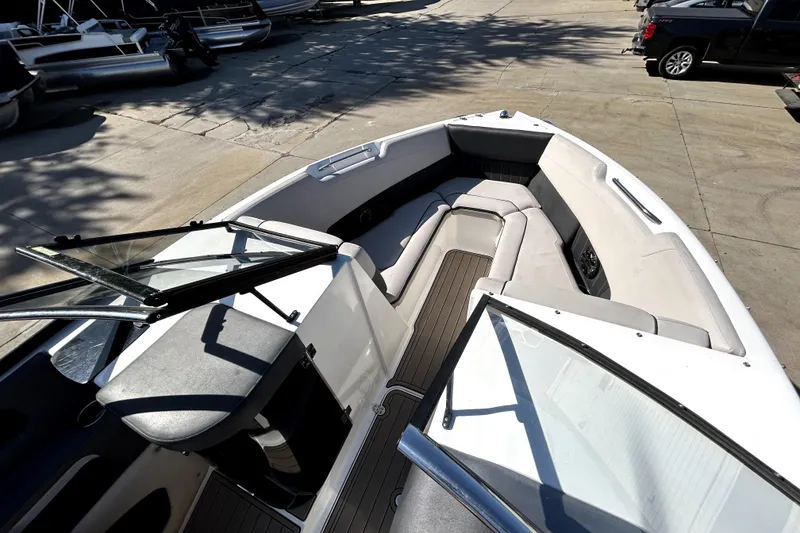 Slide: The Image of 2018 Rinker Q5 OB boat interior with spacious seating and open windshield. - 17