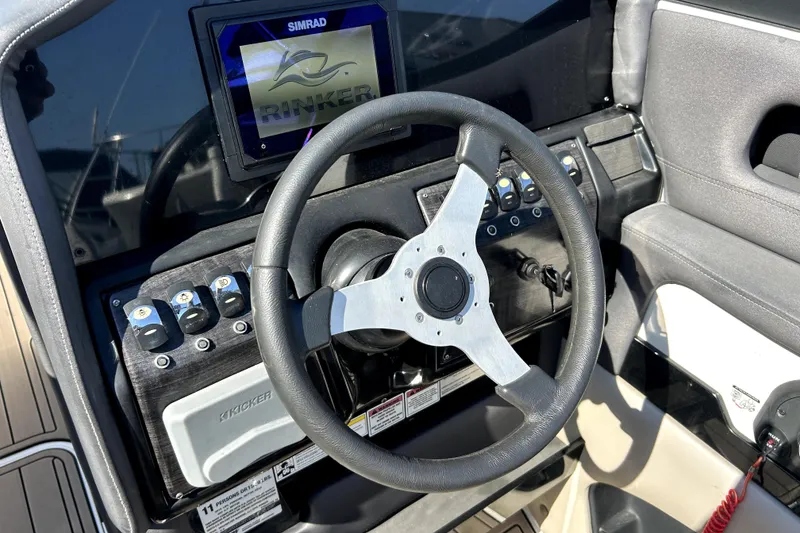 Slide: The Image of Steering wheel and dashboard of 2018 Rinker Q5 OB boat with Simrad display. - 9