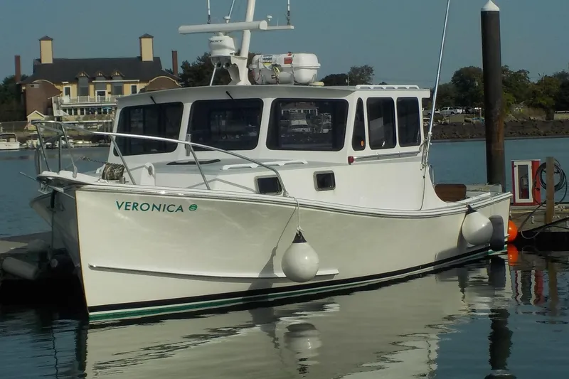 The Image of 2008 Calvin Beal Downeast boat named Veronica docked in a marina. - 0
