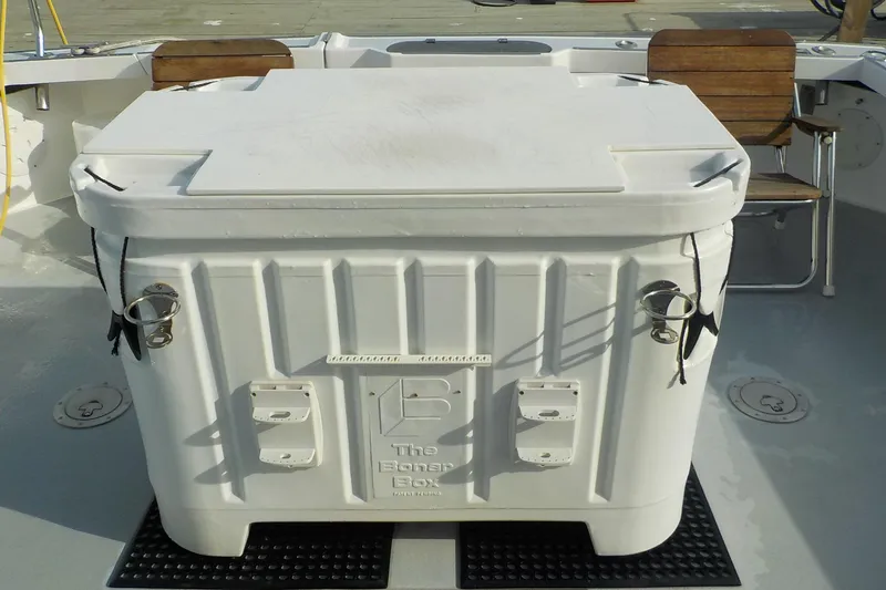Slide: The Image of 2008 Calvin Beal Downeast boat deck with large white storage box. - 12