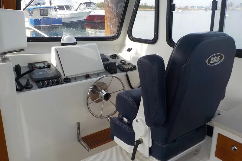 Slide: The Image of Interior helm of 2008 Calvin Beal Downeast boat with steering wheel and controls. - 13