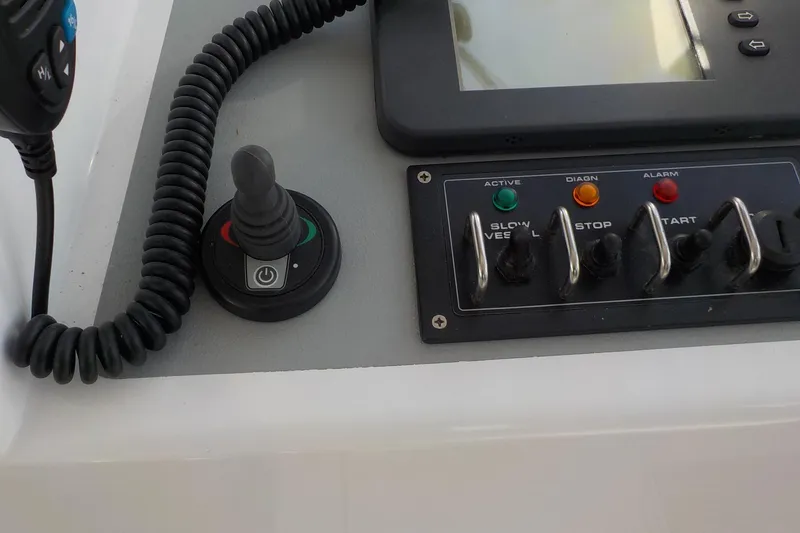 Slide: The Image of Control panel of a 2008 Calvin Beal Downeast boat with switches and joystick. - 17