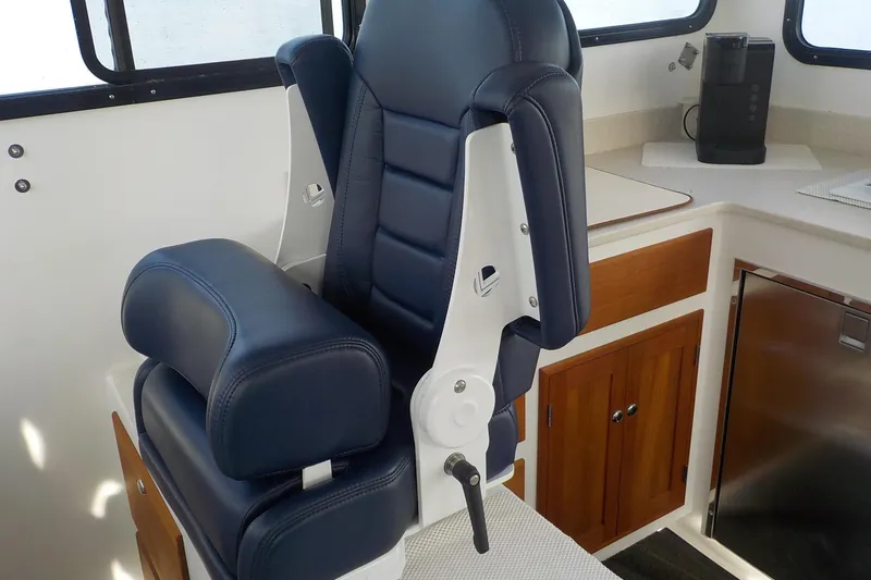 Slide: The Image of Luxurious blue captain's chair in 2008 Calvin Beal Downeast boat interior. - 21