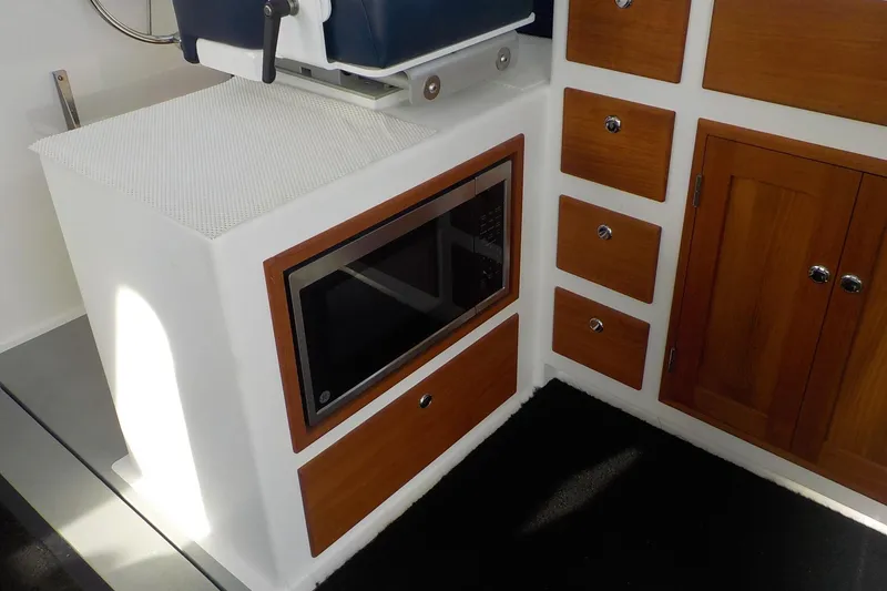 Slide: The Image of Interior of 2008 Calvin Beal Downeast boat with microwave and wooden cabinetry. - 24