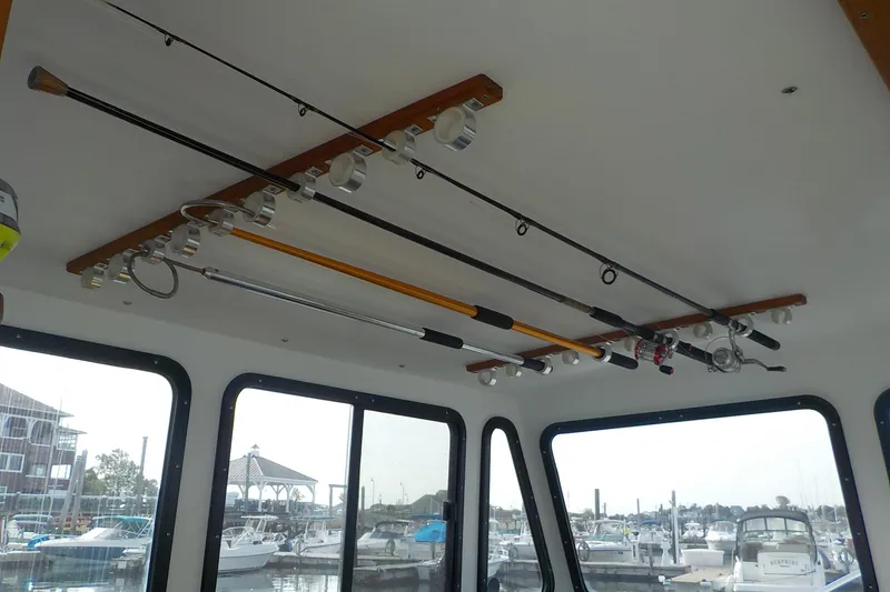 Slide: The Image of Interior of 2008 Calvin Beal Downeast boat with fishing rods on ceiling rack. - 29