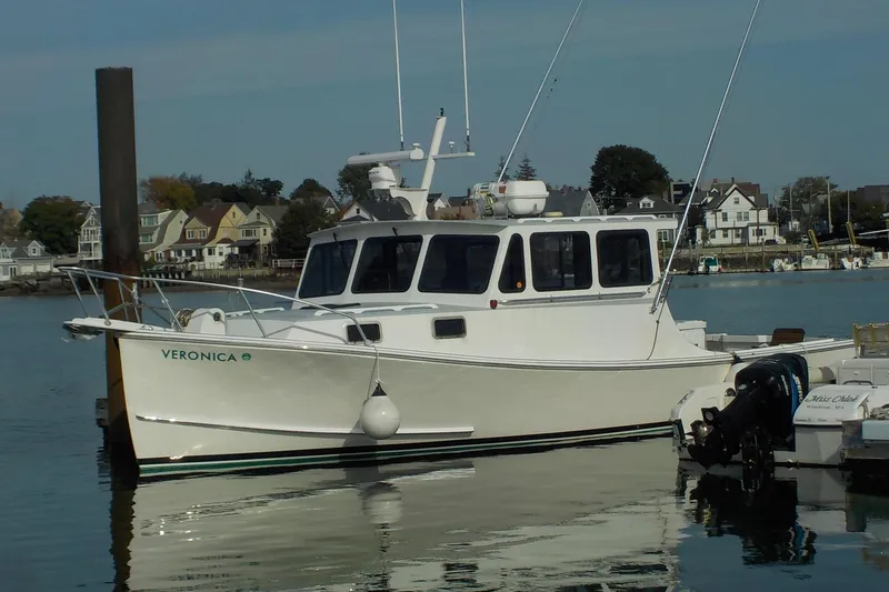 Slide: The Image of 2008 Calvin Beal Downeast boat docked in a scenic harbor setting. - 3